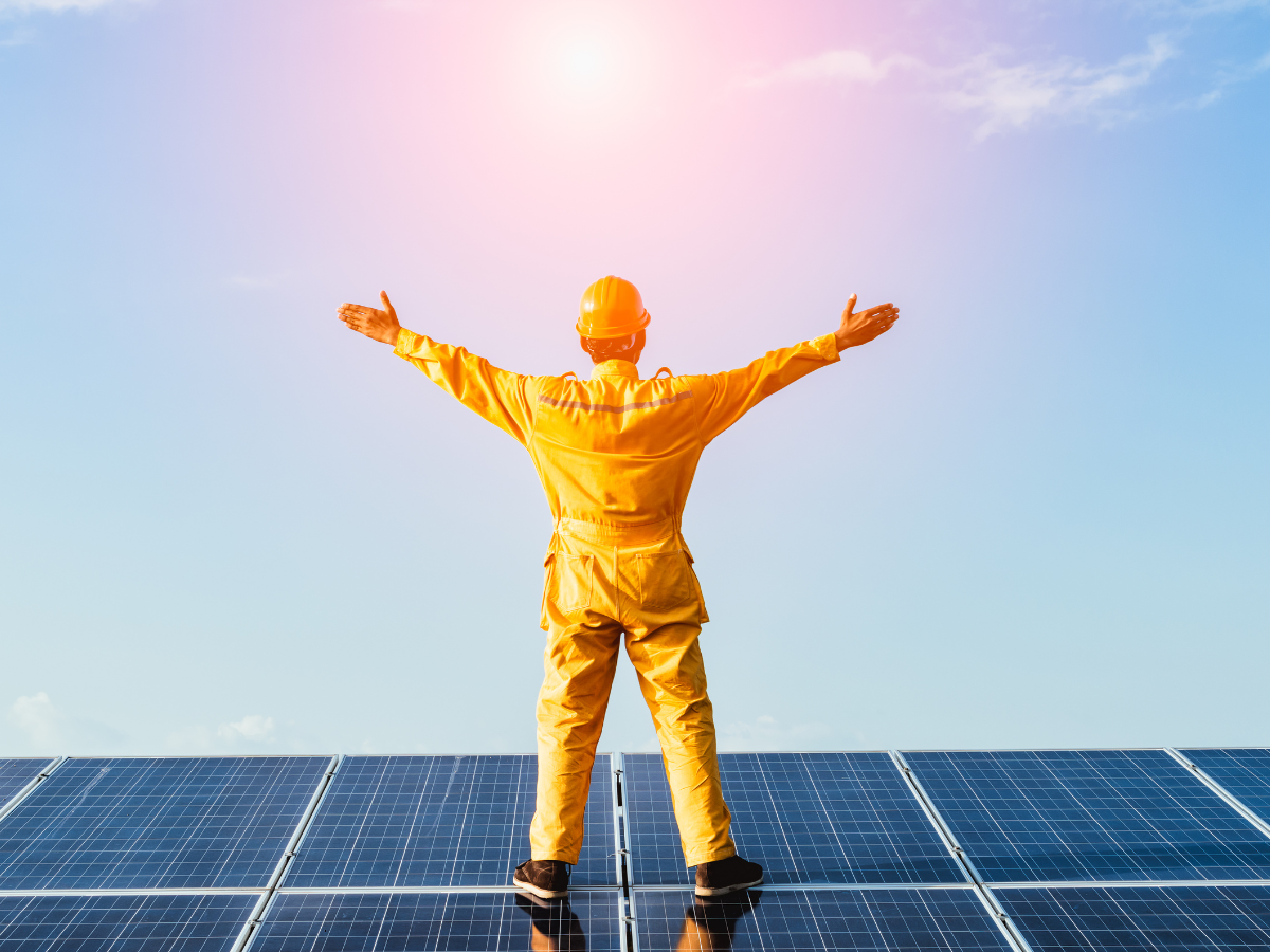 man standing on top of solar panel